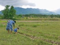 A mother, together with her little baby girl, enjoy spending time in a field in a countryside