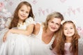 Mother together in the little daughter, sit on a floor near a festive fir-tree, play and consider gifts. Waiting for a Royalty Free Stock Photo