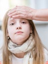 Mother touches the forehead of the child, checking the temperature