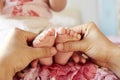 Mom massaging newborn's feet