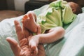 Mother touching cute little newborn baby boy feet. Royalty Free Stock Photo