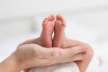 Mother touching and holding baby feet with love. Infant Tiny baby feet with mom hand relax and comfortable. Good moment of mother Royalty Free Stock Photo