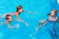 Mother train children to swim in the pool. Royalty Free Stock Photo