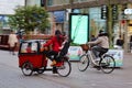 mother transporting children in bicycle