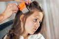 Mother treating daughter's hair against lice