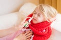 Mother treating her child`s runny nose with nasal spray Royalty Free Stock Photo