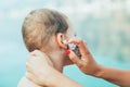 Mother treating little boy ear infection