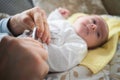 Mother trimming newborns nails on a bed Royalty Free Stock Photo