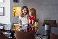 Mother tutoring daughter at home, helping her study for school