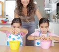 Mother and Twins Beating Eggs in Kitchen Royalty Free Stock Photo