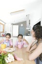 Mother and Twins Beating Eggs in Kitchen Royalty Free Stock Photo