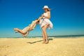 Mother twirling her son on beach