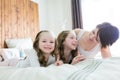Mother and two children in the bedroom on the bed Royalty Free Stock Photo