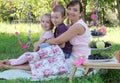 Mother with two children hugging at summer picnic Royalty Free Stock Photo