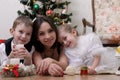 Mother and two children lying under Christmas tree Royalty Free Stock Photo