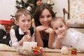 Mother and two children lying under Christmas tree Royalty Free Stock Photo