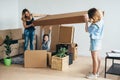 Mother two children at new home with cardboard boxes. Royalty Free Stock Photo