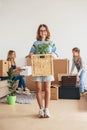 Mother two children at new home with cardboard boxes. Royalty Free Stock Photo