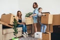 Mother two children at new home with cardboard boxes. Royalty Free Stock Photo