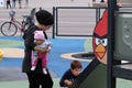 Mother with two children in a playground with an Angry Birds theme