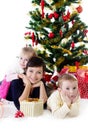 Mother with two children under Christmas tree Royalty Free Stock Photo