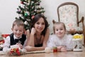 Mother and two children under Christmas tree Royalty Free Stock Photo