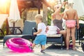 Mother with two cute caucasian blond little siblings children enjoy having fun vacation on poolside near pool or sea