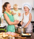 Mother with two daughters cooking Royalty Free Stock Photo