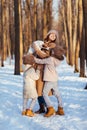 Mother with two daughters and dog in snowy forest Royalty Free Stock Photo
