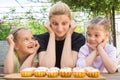 Mother and two daughters having fun and looking at easter cupcakes