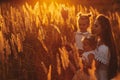 Mother and two daughters holding hands circling. Family time together at sunset. Cheerful picnic. Soft focus