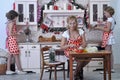 Mother and two daughters in the kitchen Royalty Free Stock Photo