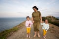 Mother and two daughters walking on a path by the sea in the evening. Cape Emine, Black sea coast, Bulgaria Royalty Free Stock Photo