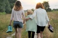 Mother and two daughters walking together along country road Royalty Free Stock Photo