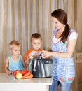 Mother with two kids doing juice