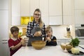 Mother and two kids kneeding dough Mother and two kids kneeding dough Royalty Free Stock Photo