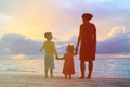 Mother and two kids walking on beach at sunset Royalty Free Stock Photo