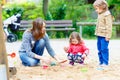 Mother and two little children playing on playground Royalty Free Stock Photo