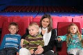 Mother with two sons and daughter in the cinema Royalty Free Stock Photo