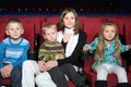 Mother with two sons and daughter watching a movie Royalty Free Stock Photo