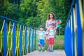 Mother with two sons at the lake, sunny spring day