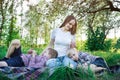 Mother and two sons on the nature. Picnic with family at the Park. Calm children