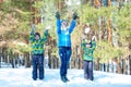 Mother and two sons walk in a snowy forest . Family Winter fun for Christmas vacation. Royalty Free Stock Photo