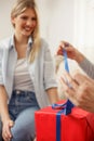 Mother unwrapping gift box she has just received from her daughter. Mother`s day. Happy family moments at home. Selective focus Royalty Free Stock Photo