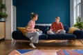 Mother and upset teenage daughter sitting on sofa having difficult conversation at home Royalty Free Stock Photo