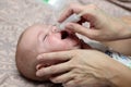 Mother using baby's nasal aspirator