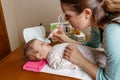 Mother using the nasal aspirator with her baby