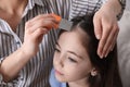 Mother using nit comb on her daughter`s hair. Anti lice treatment Royalty Free Stock Photo