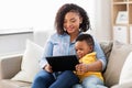 Mother using tablet pc with baby son at home Royalty Free Stock Photo