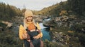 Mother walking with baby carrier in forest family traveling in Norway vacation outdoor